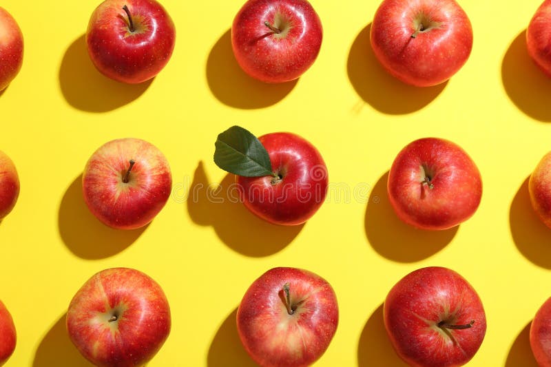 Flat lay composition with many red apples on yellow background stock image