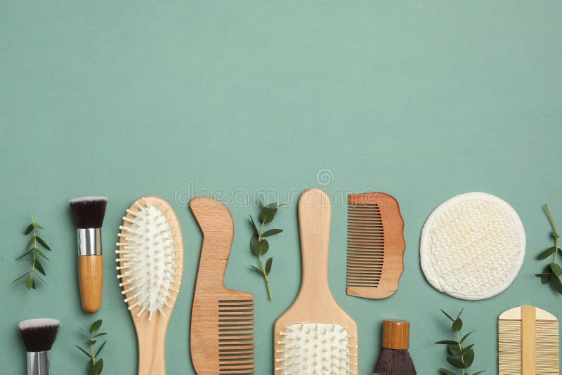 Flat Lay Composition with Hair Combs and Brushes on Green Background