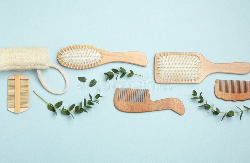 Flat Lay Composition with Modern Hair Combs and Brushes on Background