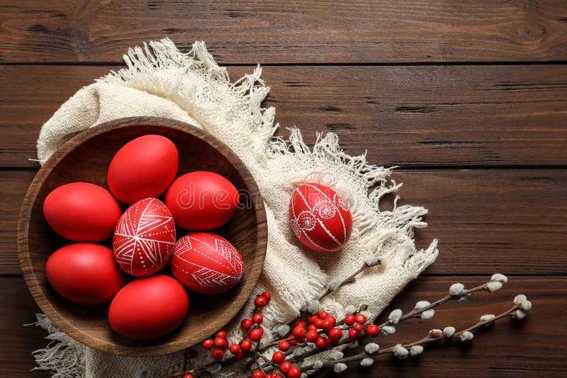 Flat lay composition with painted red Easter eggs on wooden table