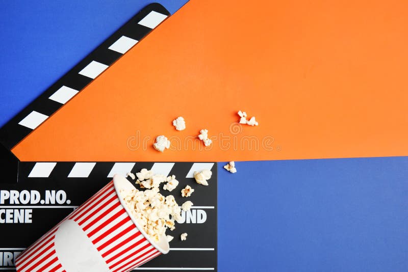 Composition with Popcorn, Cinema Clapperboard and Film Reel on Tabl