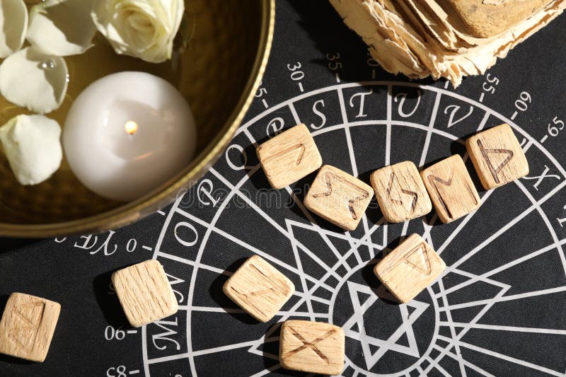 Flat lay composition with wooden runes on divination mat royalty free stock images