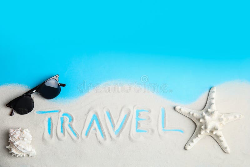 Flat lay composition with sand, sunglasses and word TRAVEL on color background, space for text