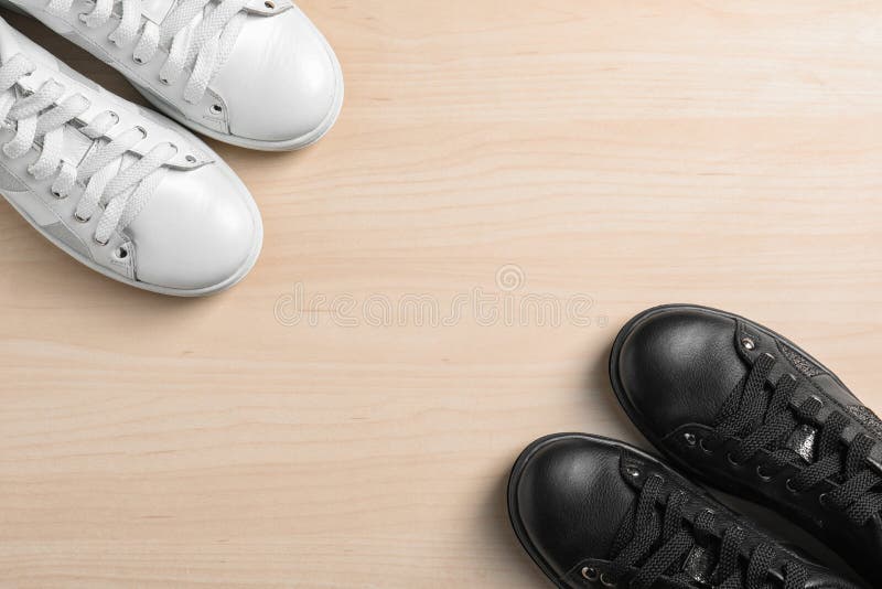 Flat Lay Composition of Stylish Modern Shoes on Wooden Background Stock