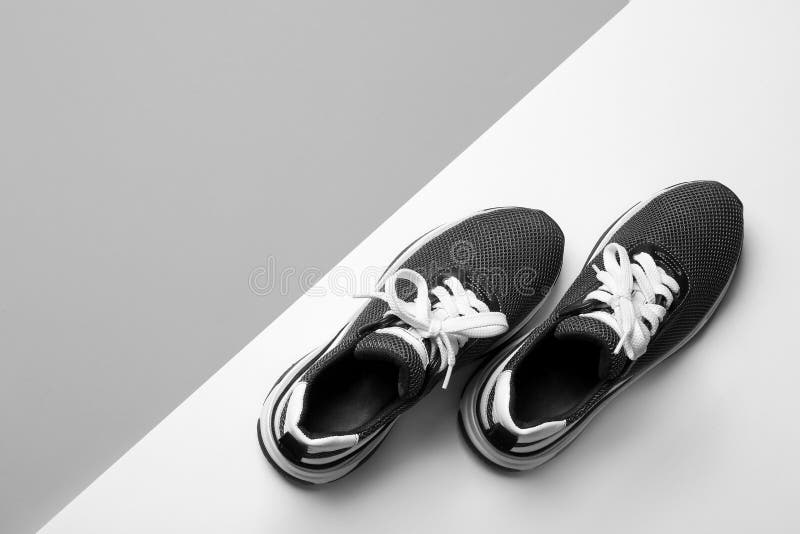 Flat lay composition of stylish training shoes on light background