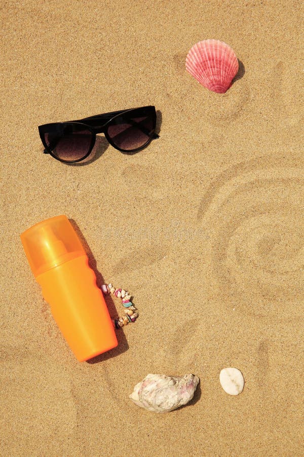 Flat lay composition with sunscreen on sand, space for text. Sun protection care royalty free stock photo