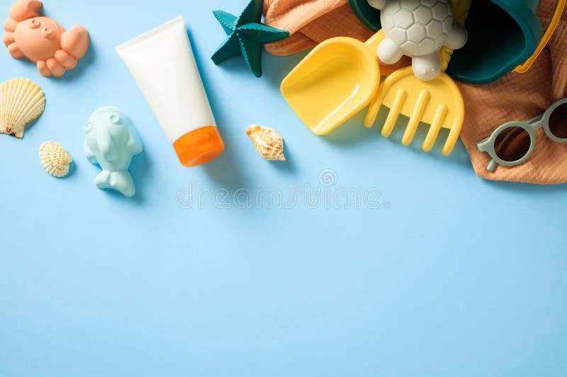 Flat lay composition with sunscreen tube and vibrant collection of beach essentials on light blue background royalty free stock photos