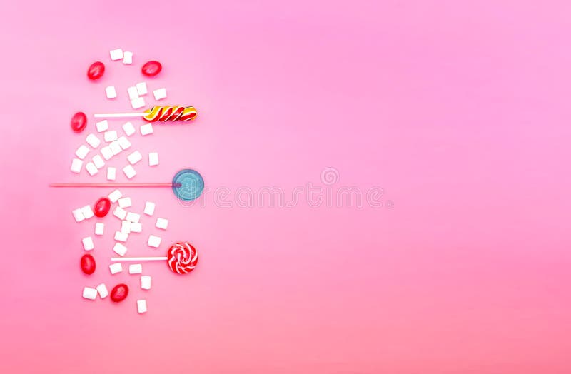 Flat lay composition with yummy lollipops and marshmallows and space for text on pink background stock image Flat lay composition with yummy lollipops and marshmallows and space for text on pink background stock image