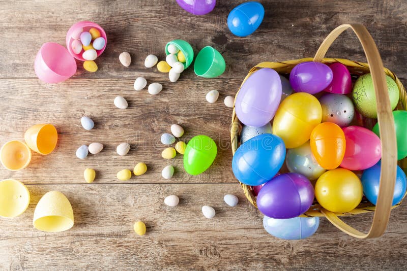 Plastic Easter Eggs Being Filled with Chocolates before Easter Egg Hunt