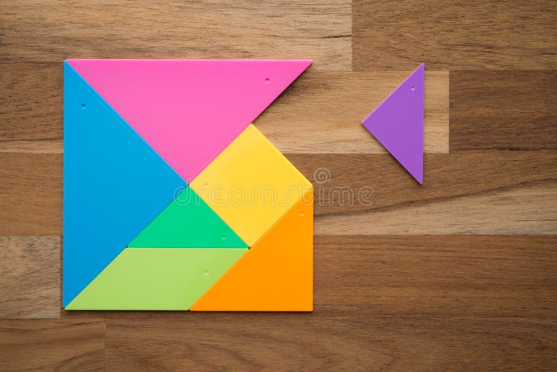 Flat lay of a missing piece in square tangram puzzle on wooden table background. Business strategy, teamwork, human resource stock photography
