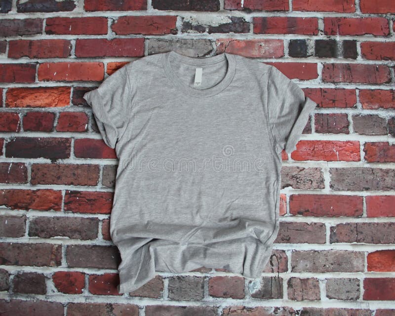 Download Gray T Shirt Mockup Flat Lay On Purple Brick Background ...