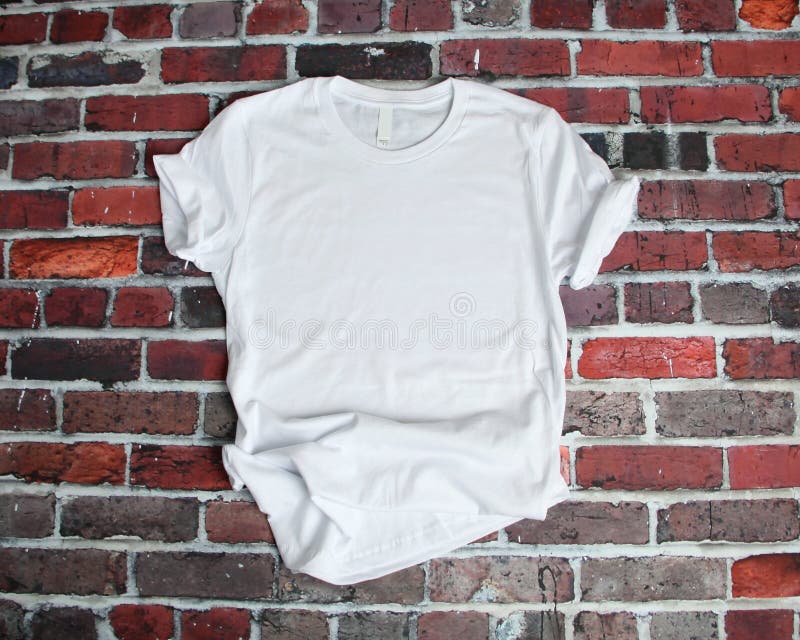 Flat lay mockup of white tee shirt on brick background