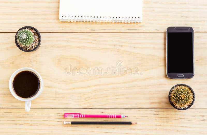 Flat lay office desk with notebooks, smart phone,pen and a cup o