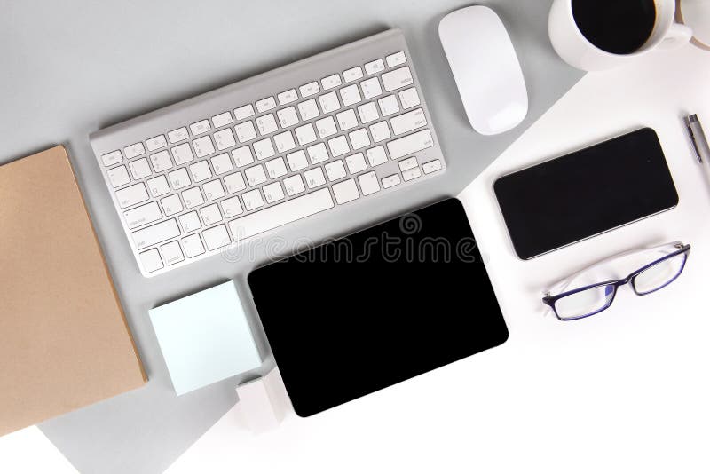 Flat lay photo of Office table with keyboard, notebook, digital tablet, mobile phone on modern two tone background