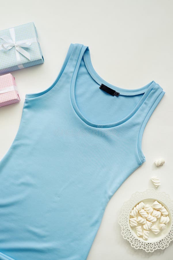 Flat lay of resents with blue yoga t-shirt for woman