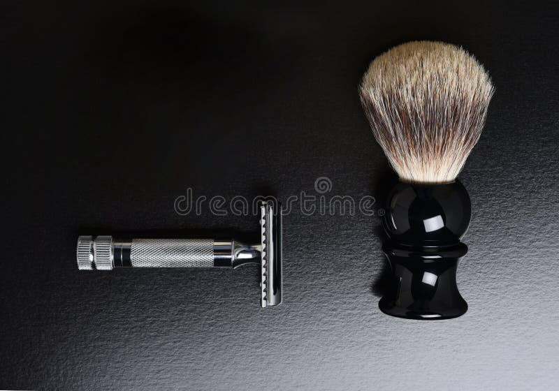 Flat Lay Shaving Still Life. A razor shaving and brush and on black