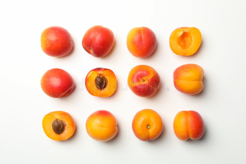 Flat lay with tasty apricots on white background top view