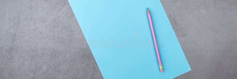 Flat lay, top view, blue sheet and pencil on a gray textured background royalty free stock image Flat lay, top view, blue sheet and pencil on a gray textured background royalty free stock image