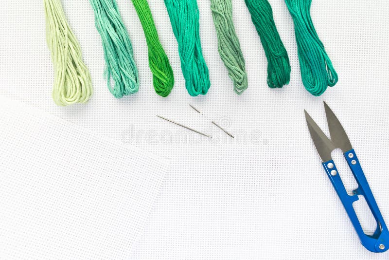 Flat Lay Top View with an Embroidery Canvas, Needles, Threads in Green