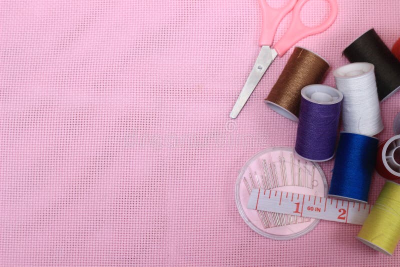 Flat lay or top view, needle, scissor, thread, tailor Meter, at Pink Background royalty free stock photography