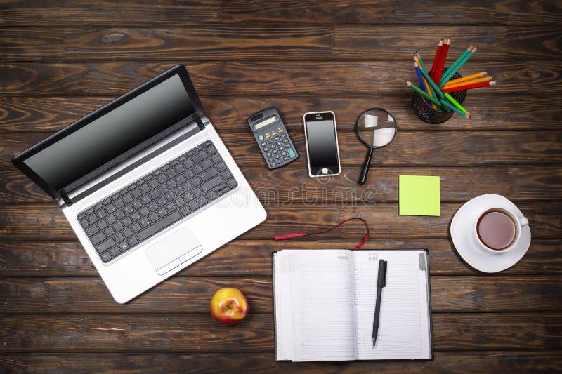 Concept freelancing, business concept, office table desk, laptop, empty notebook, cup of coffee, smartphone, calculator, wooden ba royalty free stock image Concept freelancing, business concept, office table desk, laptop, empty notebook, cup of coffee, smartphone, calculator, wooden ba royalty free stock image