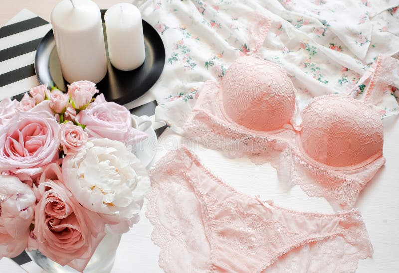 Flat lay. Top view pink lace lingerie. Beauty blog. Bouquet of roses and pions, parfume, jewelry, coffee on white bed background royalty free stock images Flat lay. Top view pink lace lingerie. Beauty blog. Bouquet of roses and pions, parfume, jewelry, coffee on white bed background royalty free stock images