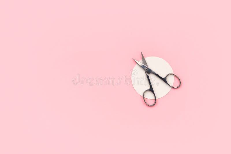Flat lay top view scissors for manicure on pink background royalty free stock photo