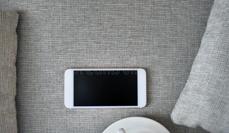 Flat Lay, Top view smartphone mockup and a cup of black coffee on fabric textile with copy space, digital NOMAD, freelancer stock image