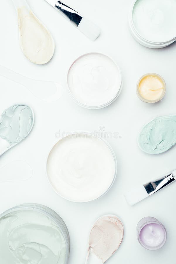 flat lay with various clay masks in containers, spoons and brushes stock images flat lay with various clay masks in containers, spoons and brushes stock images