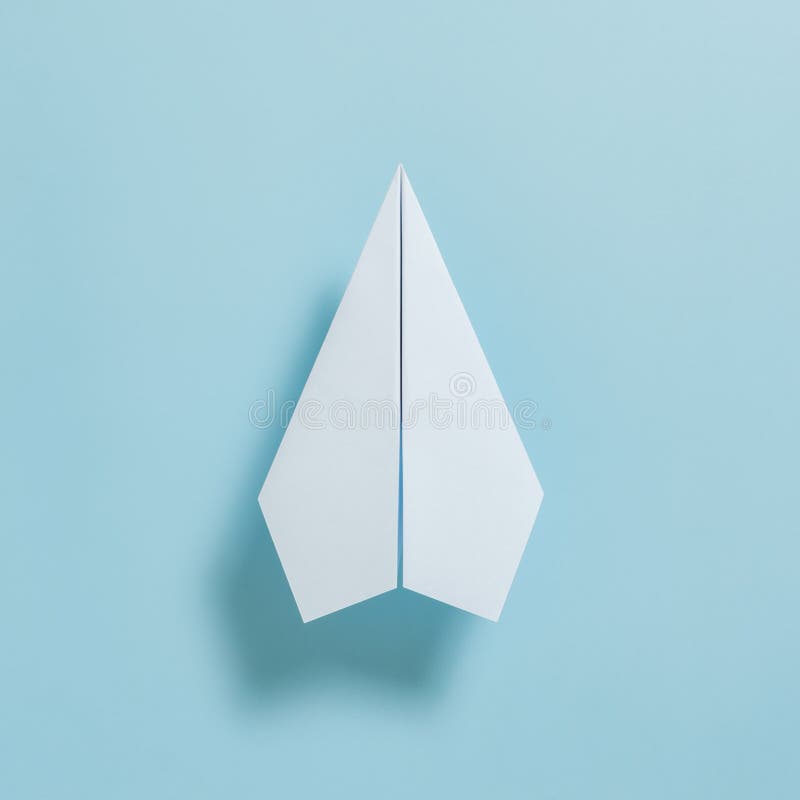 Flat Lay Of White Paper Plane On Pastel Blue Color Background Stock