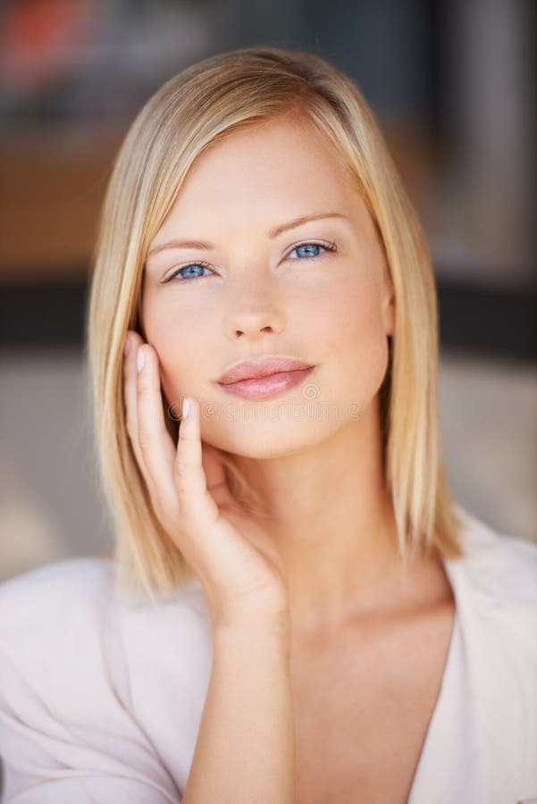 Flawless complexion. A beautiful young woman smiling at the camera - closeup.