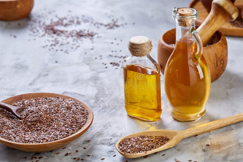 Flax Seeds in Bowl and Flaxseed Oil in Glass Bottle on Light Textured ...