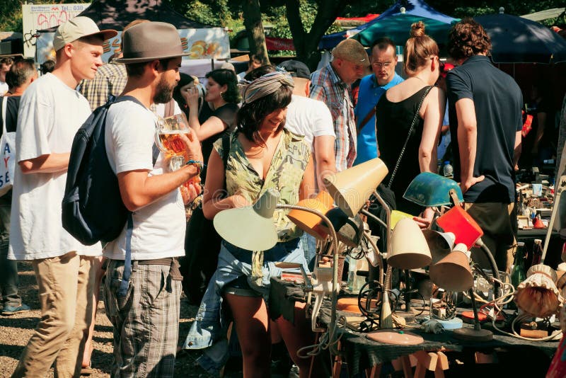 Flea market with people choosing vintage furniture