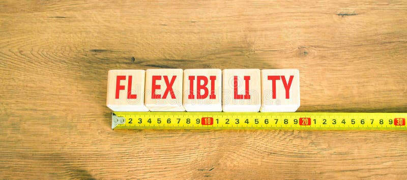 Flexibilitetssymbol. Begreppsflexibilitet för vackra träkuber. vacker bakgrund av trä. vacker gul linjal. royaltyfri bild