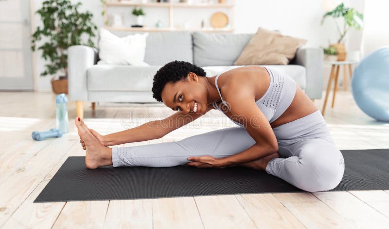 Flexibility Exercises. Athletic Young Woman Doing Yoga on Mat, Stretching  Her Legs during Home Workout Stock Image - Image of epidemic, active:  206485569