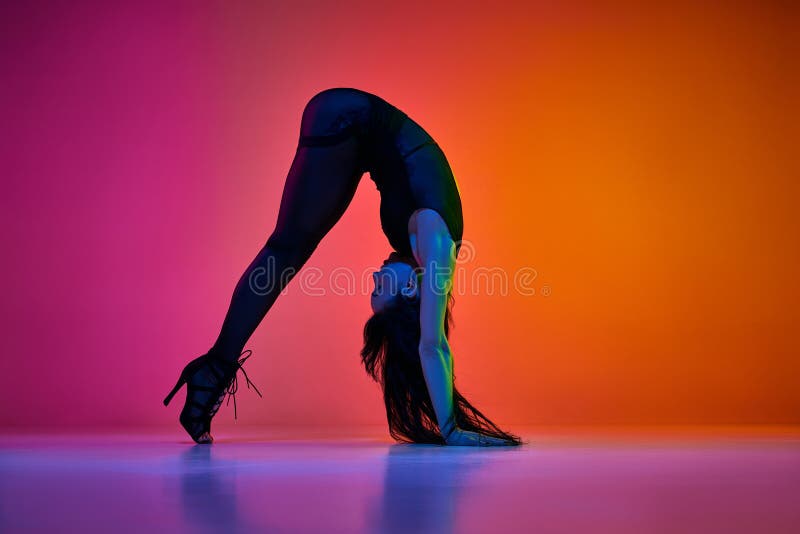 Flexibility. Young Woman Dancing Modern Dance Style Over Gradient Pink Orange Studio Background