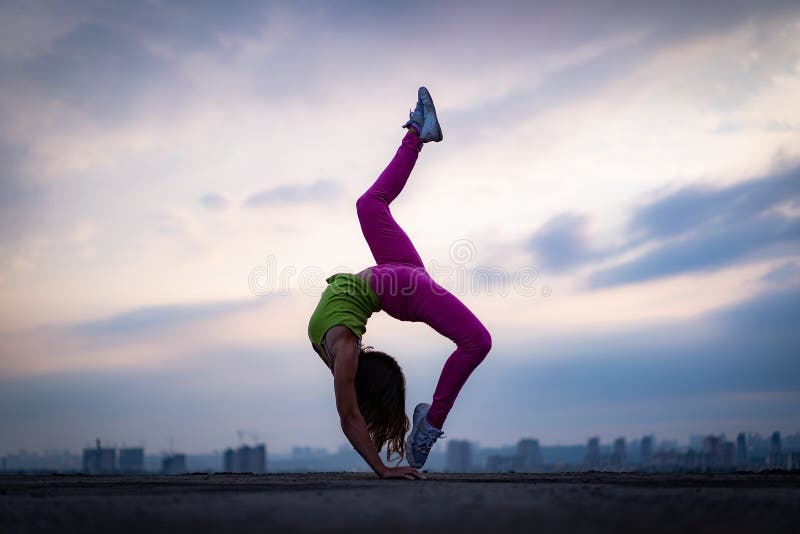 Woman Doing Yoga Poses Outside In A Park Stock Photo, Picture and Royalty  Free Image. Image 48013765.
