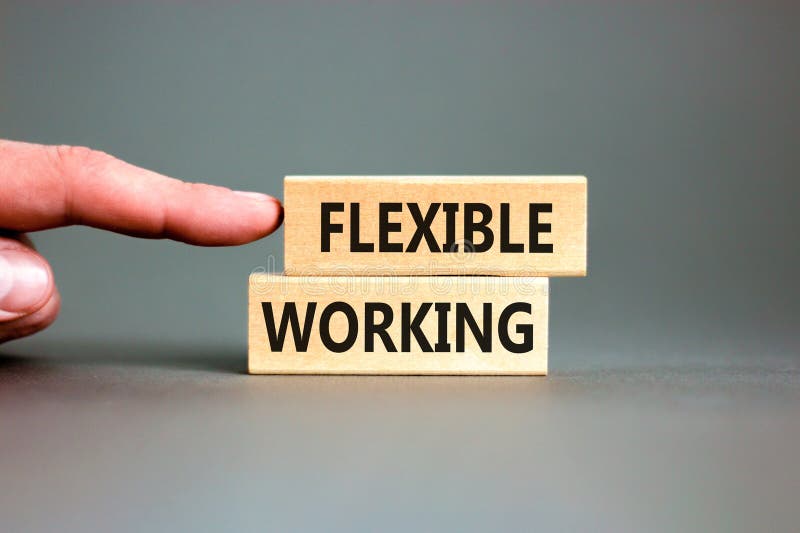 Flexible working symbol. Concept words Flexible working on beautiful wooden block. Beautiful grey paper background. Businessman royalty free stock images