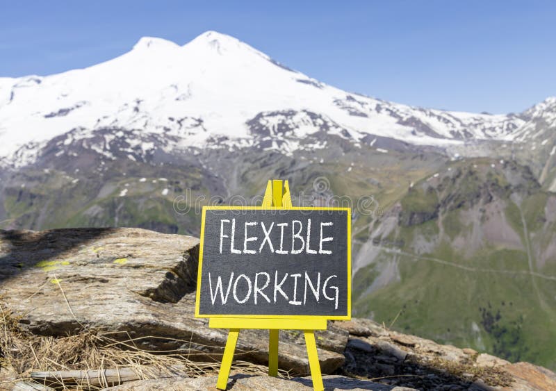 Flexible working symbol. Concept words Flexible working on beautiful yellow blackboard. Beautiful mountain Elbrus background. stock photos