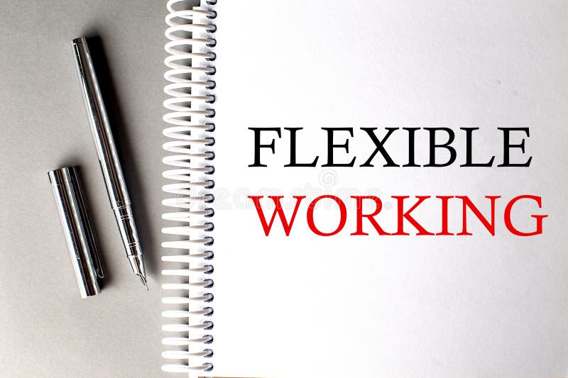 FLEXIBLE WORKING text on a notebook with pen on grey background stock photo