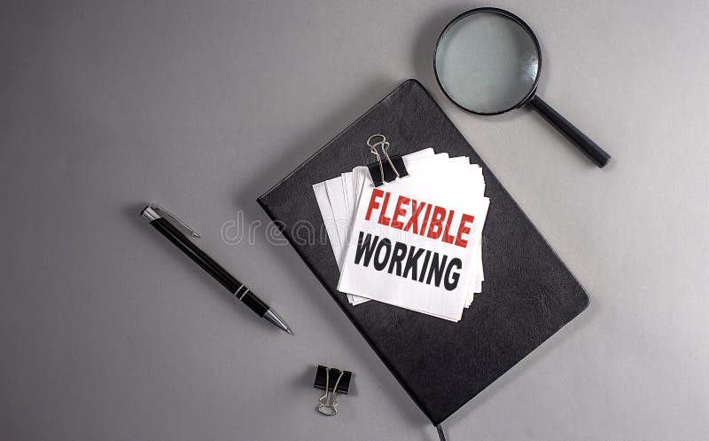 FLEXIBLE WORKING Text on a sticky on black notebook , business concept stock image