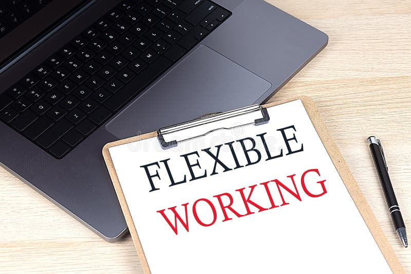 FLEXIBLE WORKING text written on a paper clipboard on laptop royalty free stock photography