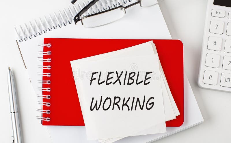 FLEXIBLE WORKING word on sticker on notepad with pen and calculator stock image