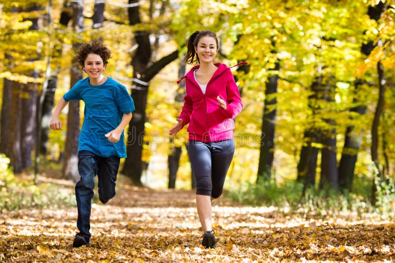 Girl and boy playing in autumn park. Girl and boy playing in autumn park