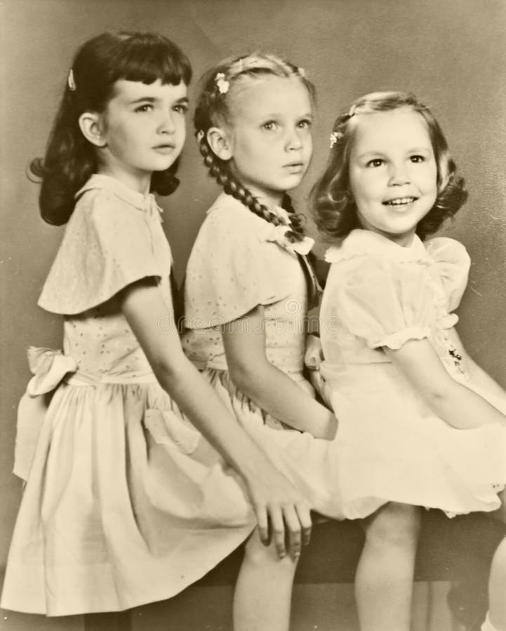 Three girls, cousins, dressed in the styles of the 1950's. Three girls, cousins, dressed in the styles of the 1950's.