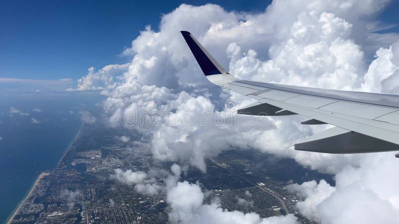 Fliegen über Miami. Angaben der Ostküste vom Flächenfenster. schöne weiße Wolken gegen blauen Himmel. das Türkiswasser