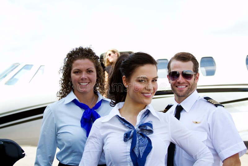 Flight crew in front of plane stock photo