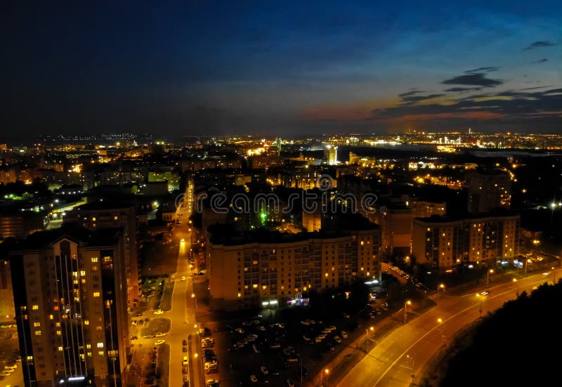 Flight on drone above night city with asphalt city roads, residential buildings and car traffic at night royalty free stock images Flight on drone above night city with asphalt city roads, residential buildings and car traffic at night royalty free stock images