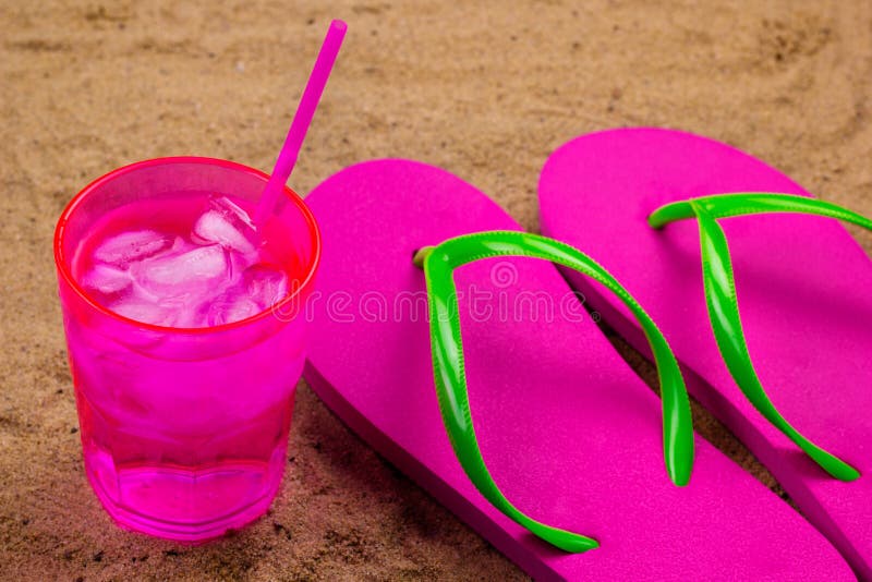 Flip Flops and Cold Drink with Ice on a Sand Stock Image - Image of