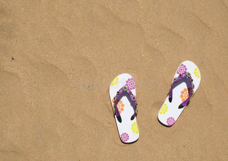 Trendy flip-flops on the sand. Trendy flip-flops on the sand